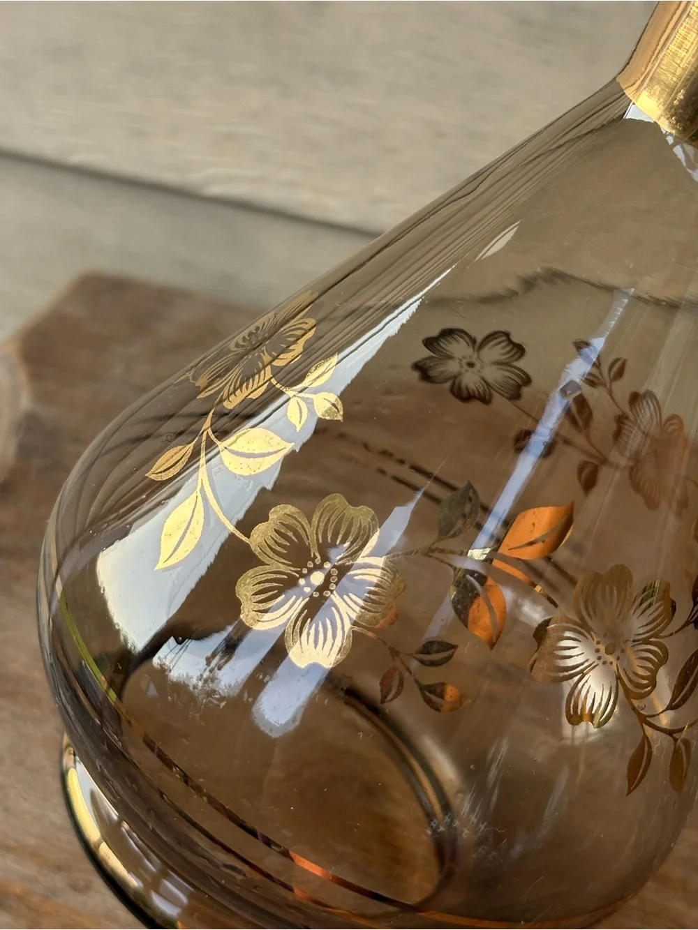 Art Deco decanter set features smoky purple glass adorned with a gold floral
